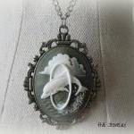 Oval Dolphin Pendant On Antique Silver Chain..