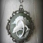 Oval Dolphin Pendant On Antique Silver Chain..